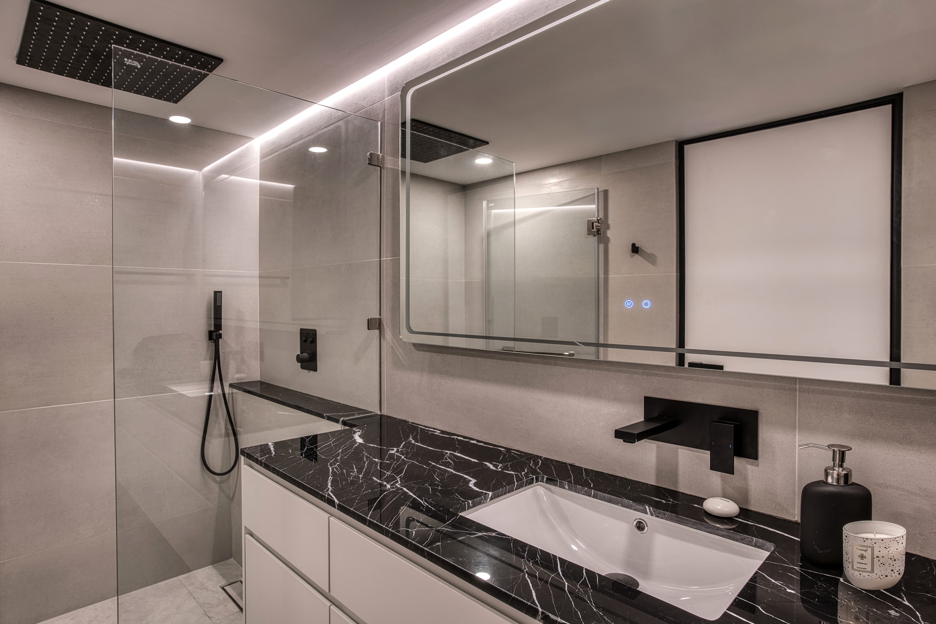Essence Residences bathroom โ rainfall shower, clean design